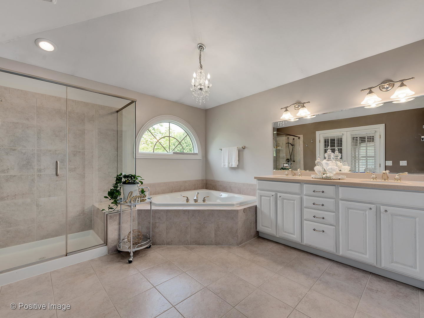 27W617 Garys Mill Road Winfield, IL 60190 - Photo 18 of 35 a spacious bathroom with a tub sink and mirror