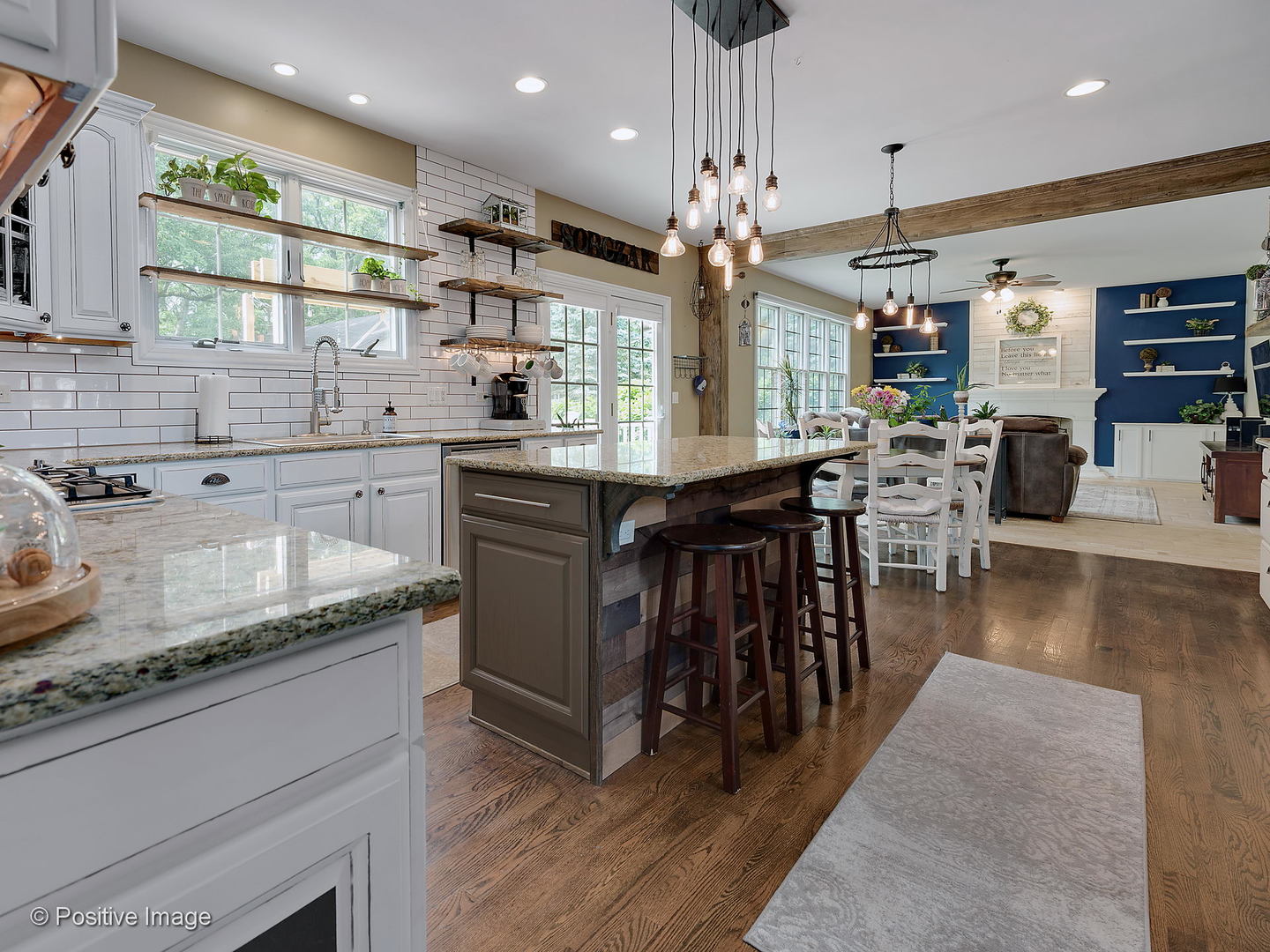 27W617 Garys Mill Road Winfield, IL 60190 - Photo 8 of 35 a kitchen with stainless steel appliances granite countertop a stove top oven a sink dishwasher a dining table and chairs with wooden floor