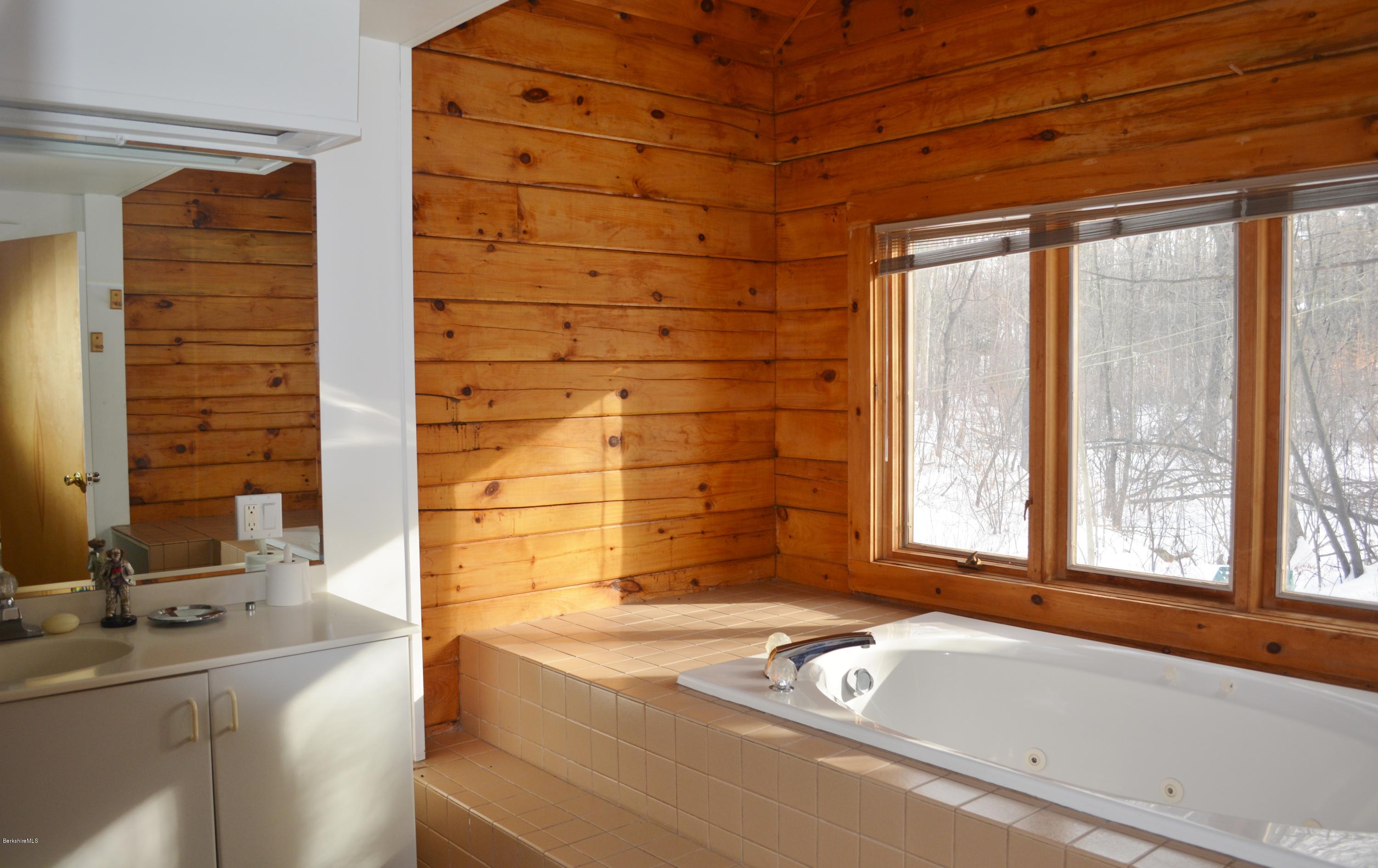 670 Bonny Rigg Hill Road Becket, MA 01223 - Photo 12 of 23 a bathroom with a tub and a sink