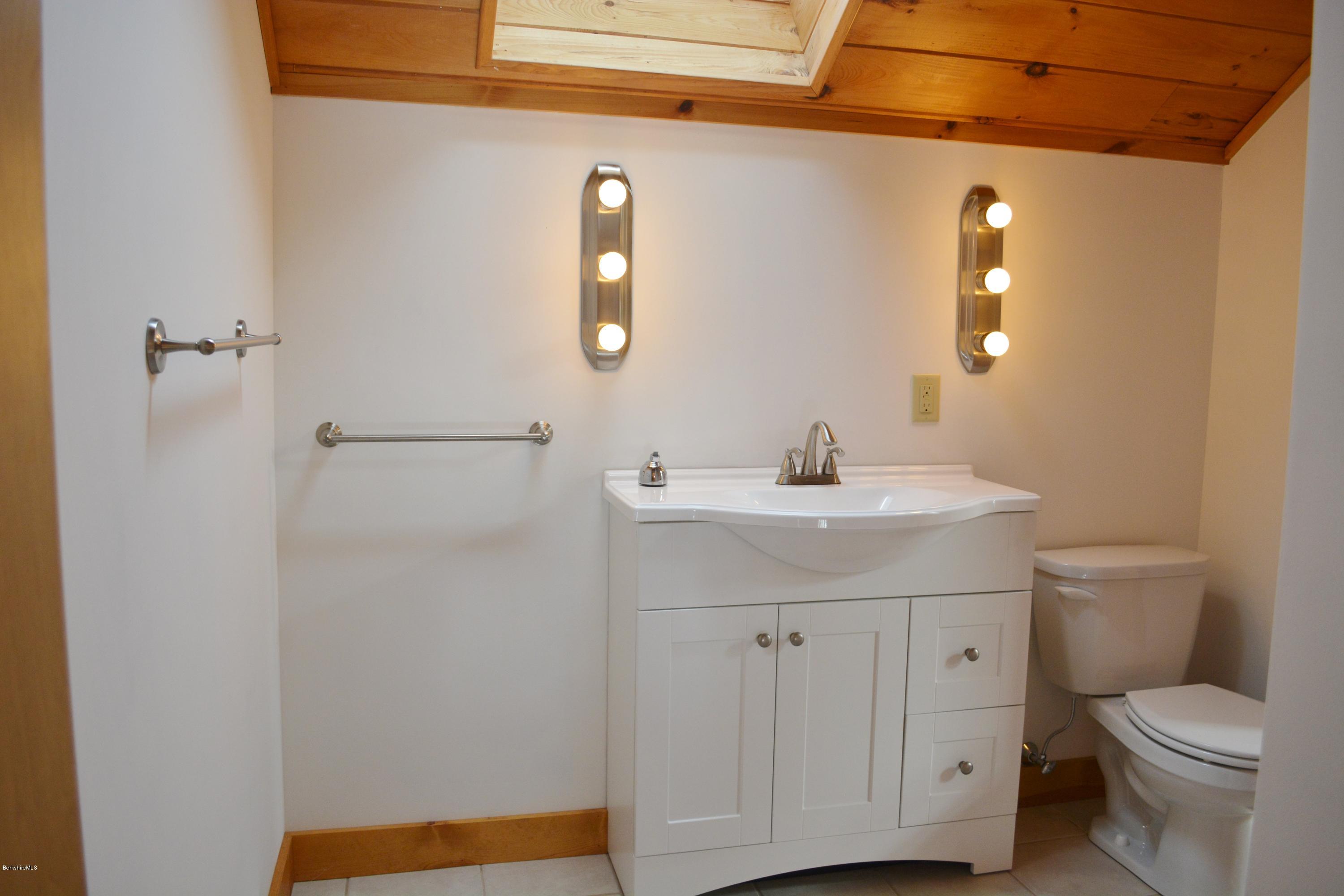 670 Bonny Rigg Hill Road Becket, MA 01223 - Photo 15 of 23 a bathroom with a sink a toilet and shower
