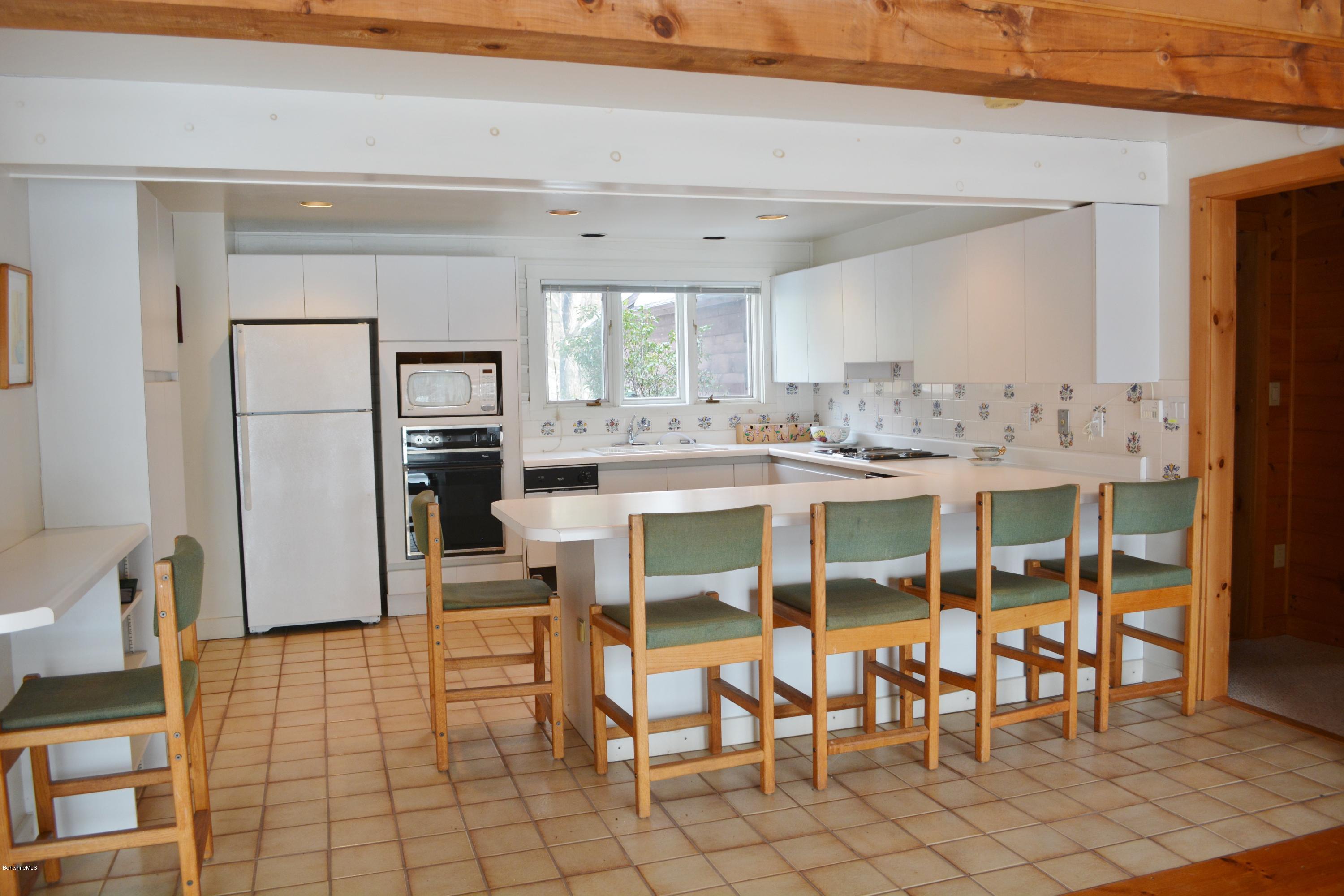 670 Bonny Rigg Hill Road Becket, MA 01223 - Photo 6 of 23 a view of a dining room with furniture and a chandelier