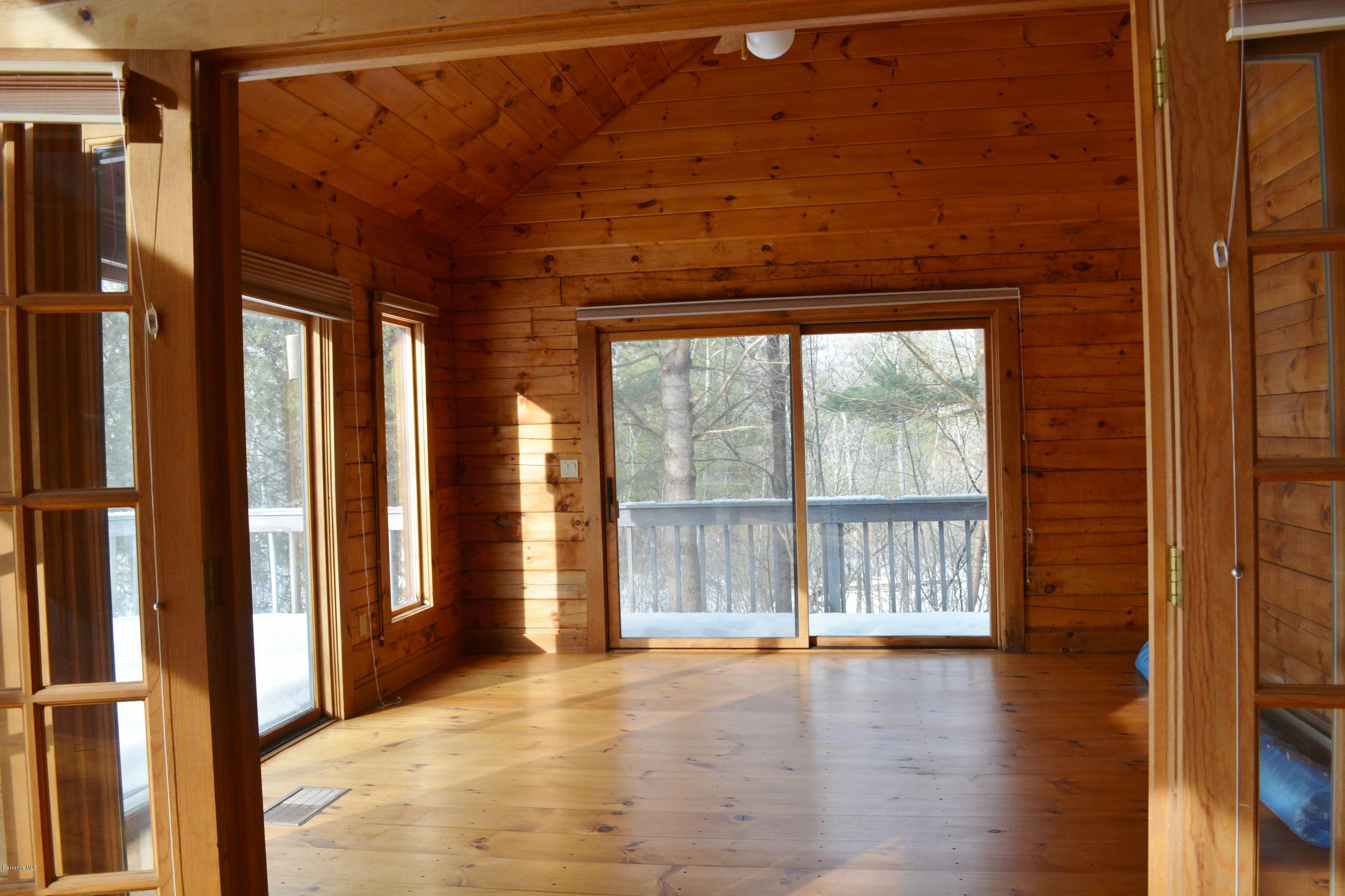 670 Bonny Rigg Hill Road Becket, MA 01223 - Photo 8 of 23 a view of an empty room with wooden floor and a window