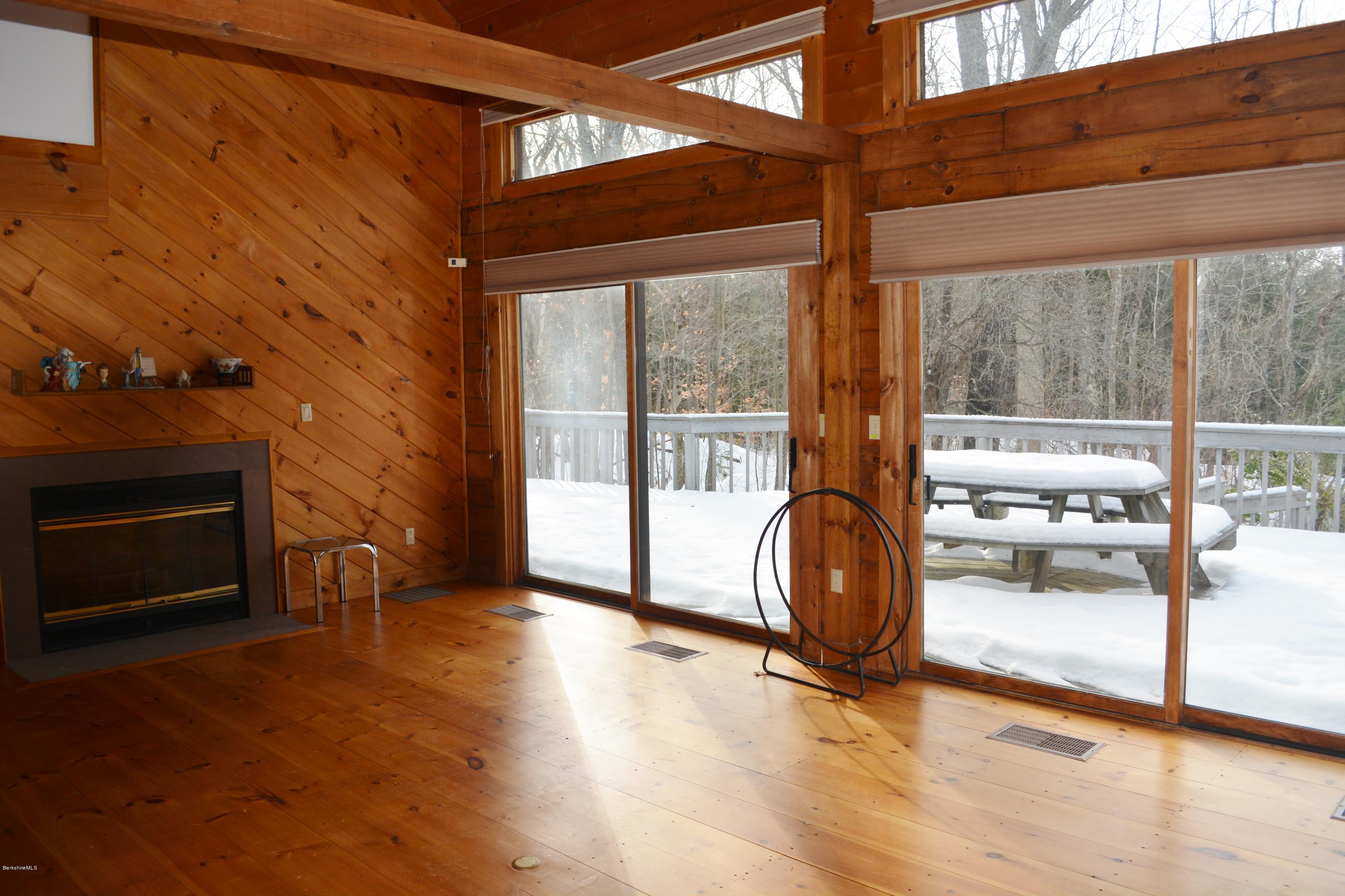 670 Bonny Rigg Hill Road Becket, MA 01223 - Photo 9 of 23 a view of workspace with wooden floor and fireplace