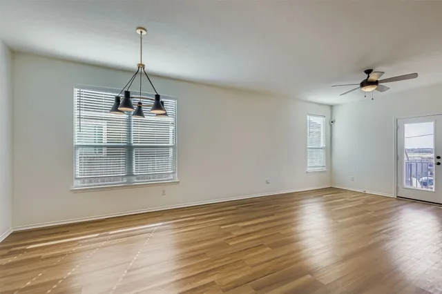 a large kitchen with a chandelier and stainless steel appliances