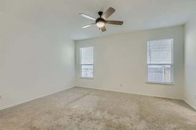a large kitchen with a lot of counter space and wooden floor