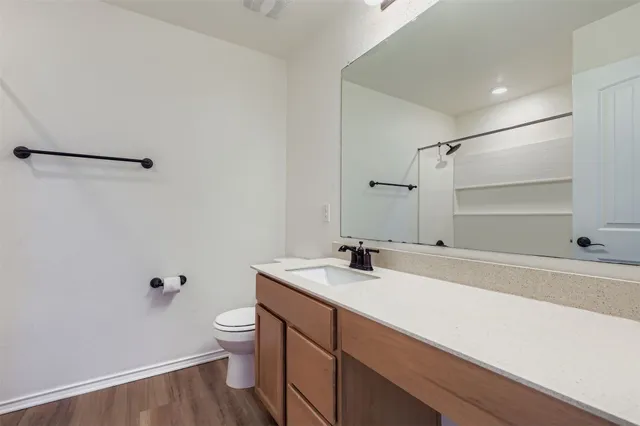 a bathroom with a sink a toilet and mirror