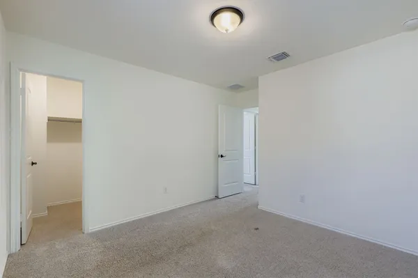 an empty room with closet area