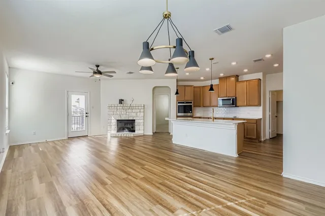 a view of a backyard with table and chairs potted plants and wooden fence