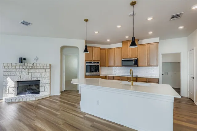 a view of a house with backyard and chairs
