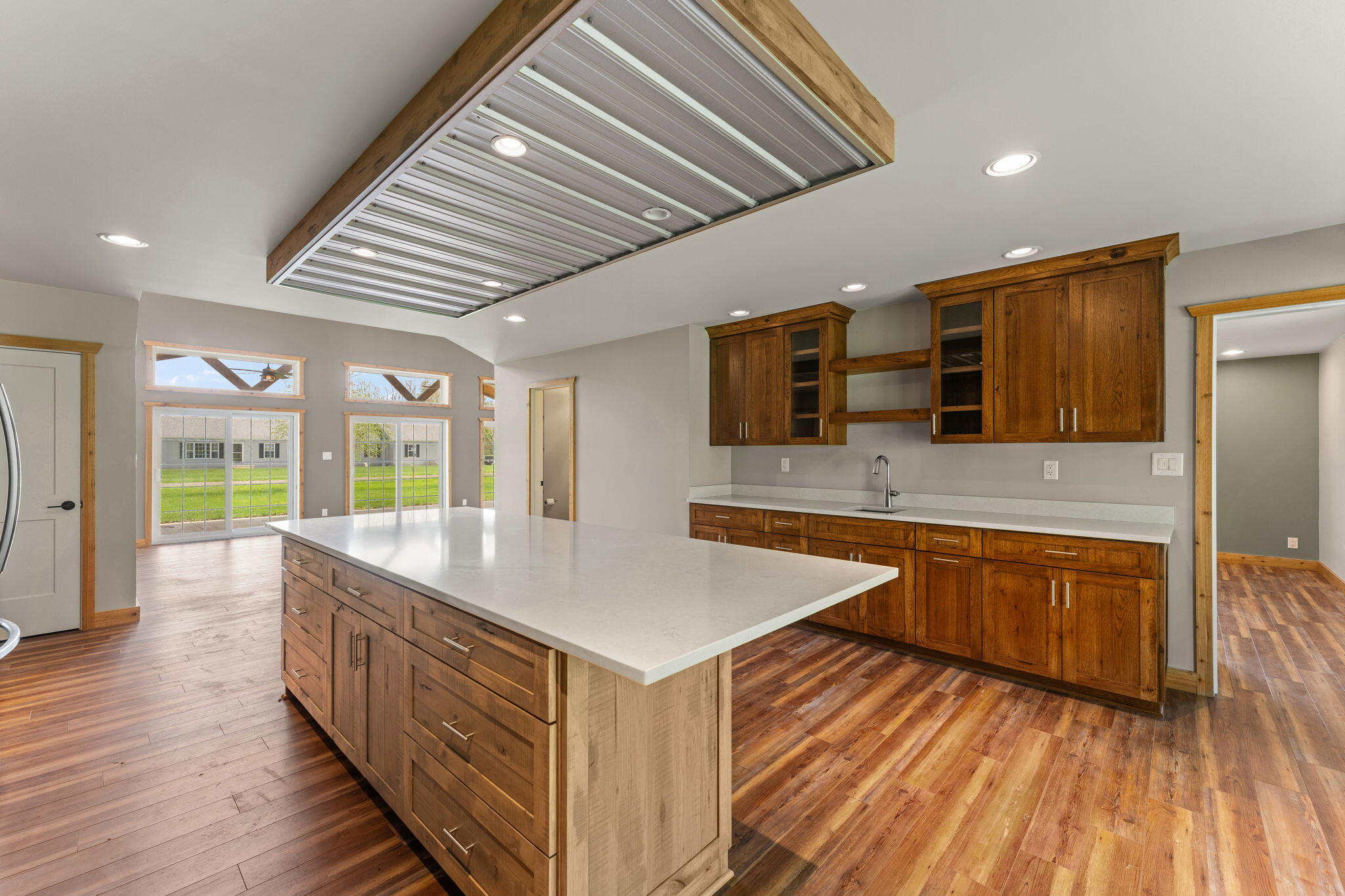 6631 Beach Street Knox, IN 46534 - Photo 12 of 41 a large kitchen with stainless steel appliances granite countertop a large counter top and a wooden floors