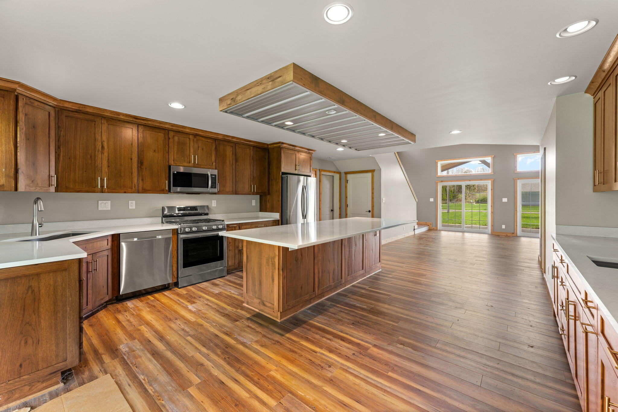 6631 Beach Street Knox, IN 46534 - Photo 6 of 41 a kitchen with stainless steel appliances kitchen island granite countertop a stove a sink and a refrigerator