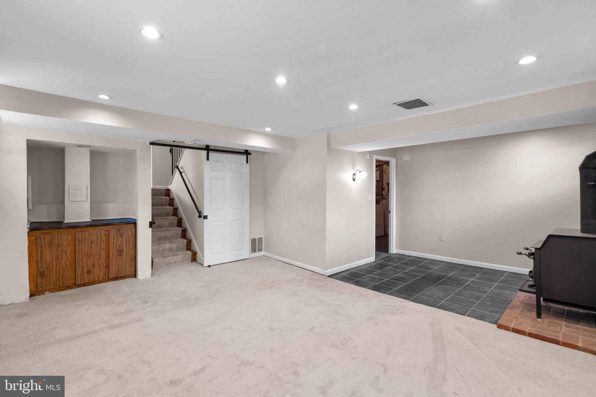 12840 Littleton Street Silver Spring, MD 20906 - Photo 22 of 33 Family Room with Sliding Barn Door to Main Level
