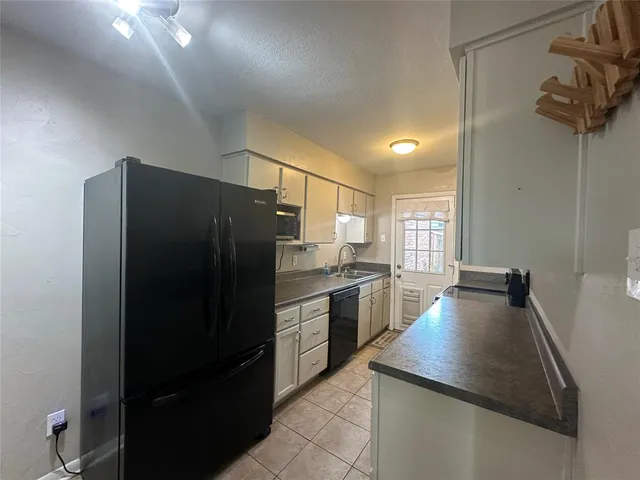 a kitchen with refrigerator and window