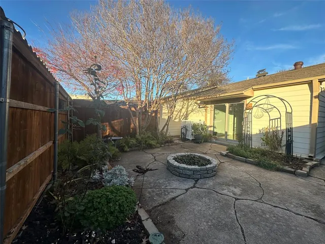 a view of a patio with table and chairs and potted plants