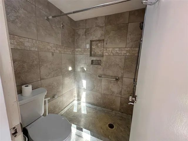 a bathroom with a shower and toilet