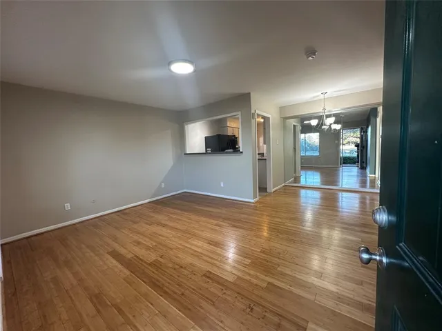 an empty room with wooden floor and fire place