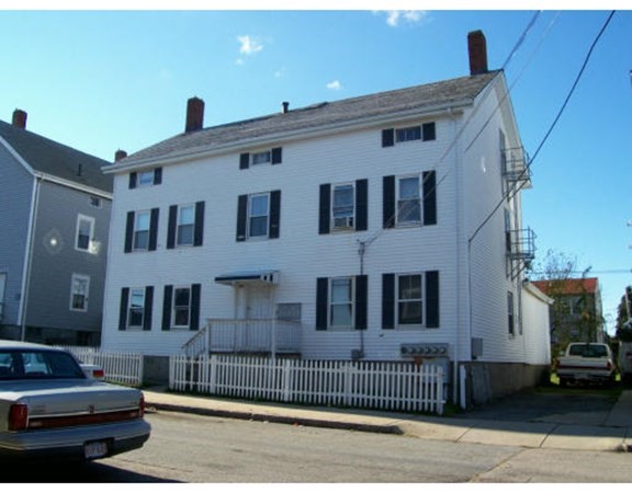 137 5th Street Fall River, MA 02721 - Photo 1 of 8 a front view of a house with a yard