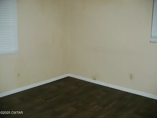 an empty room with wooden floor