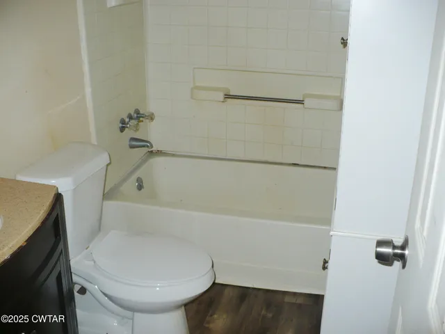 a bathroom with a toilet and a bathtub