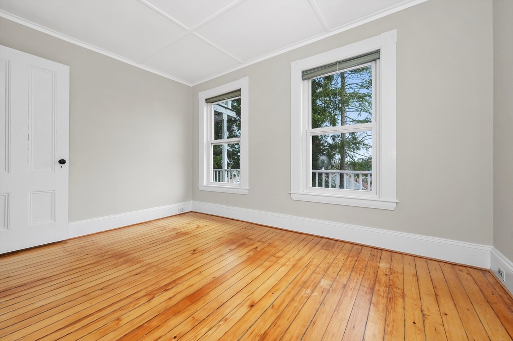 18 Bennett Street, Unit 2 Manchester, MA 01944 - Photo 17 of 21 a view of an empty room with wooden floor and a window