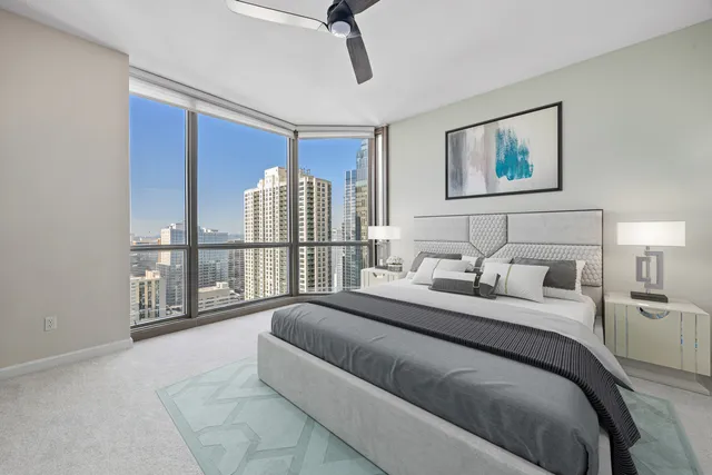 a bedroom with a balcony a bed and a painting on the wall