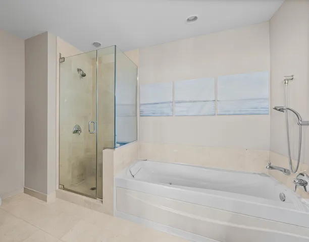 a bathroom with a bathtub and a shower