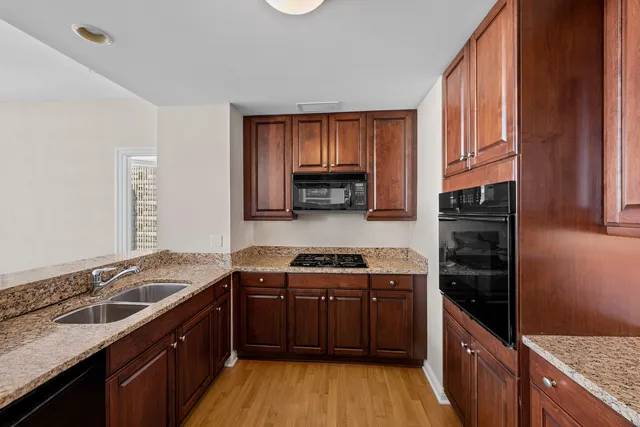 a kitchen with a sink stove top oven and cabinets