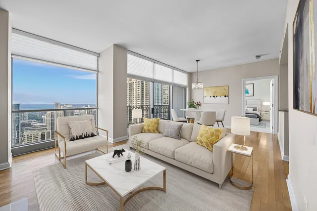a living room with furniture white walls and wooden floor