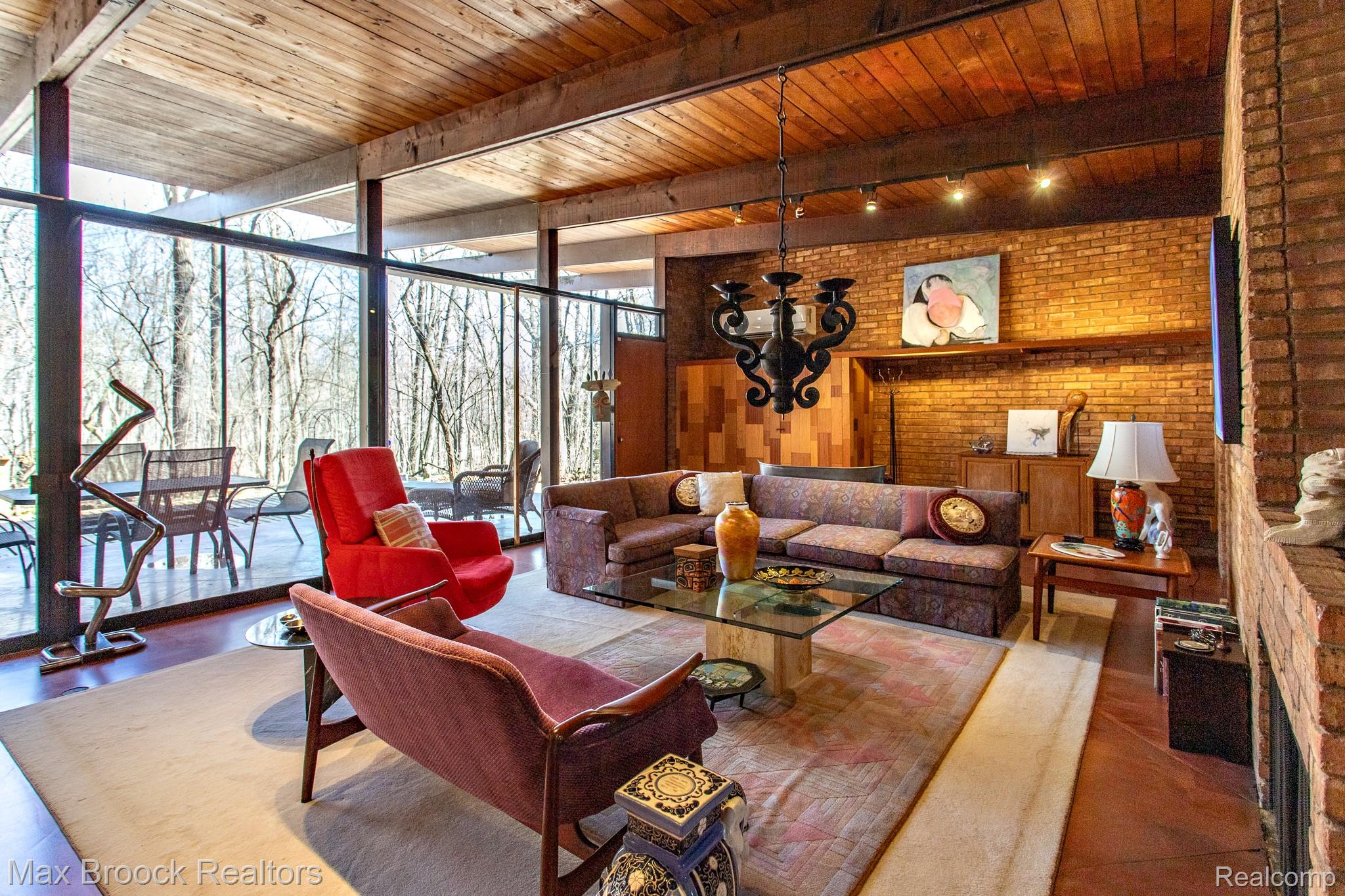 30875 Franklin Road Franklin, MI 48025 - Photo 13 of 86 Living room featuring floor to ceiling windows, a wooden ceiling with exposed beams, and brick wall