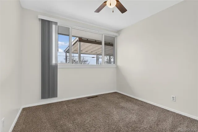 a view of a hallway with wooden floor and closet