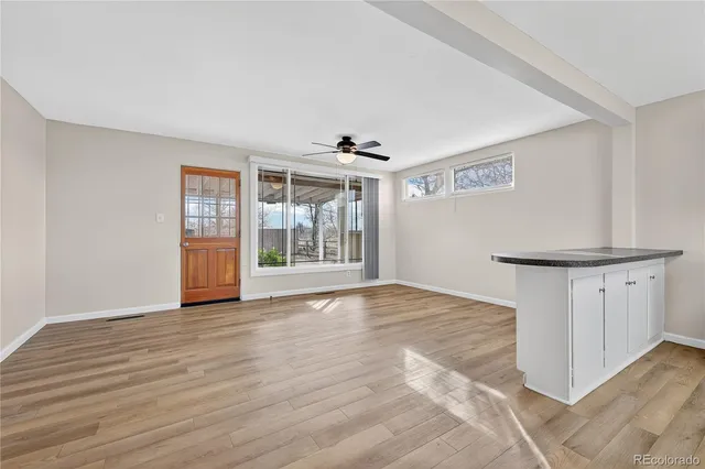 a view of a kitchen with wooden floor and a kitchen