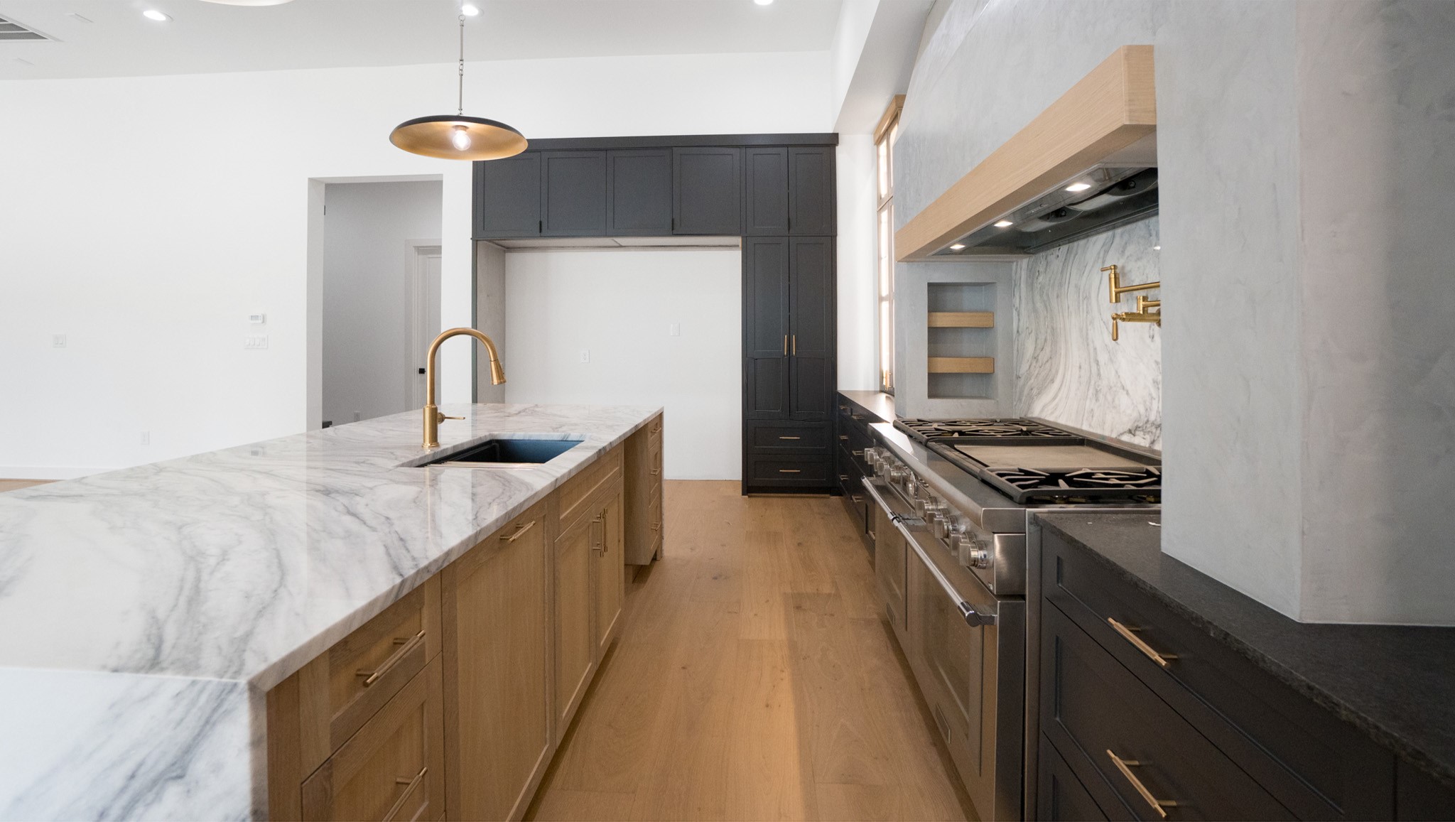 1731 Benbow Way Houston, TX 77080 - Photo 15 of 15 a kitchen with kitchen island a counter space a sink stove and cabinets