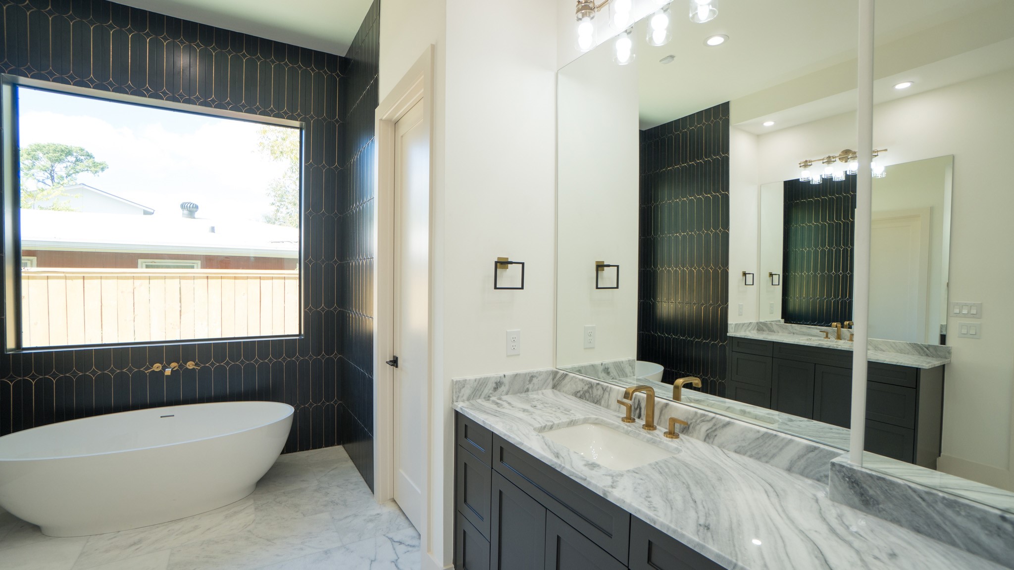 1731 Benbow Way Houston, TX 77080 - Photo 10 of 15 a bathroom with a granite countertop tub sink and mirror
