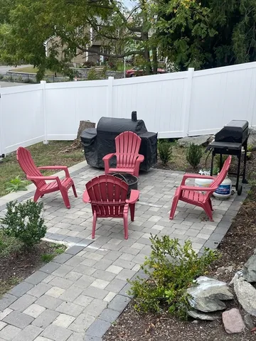 an outdoor sitting area with furniture and garden view