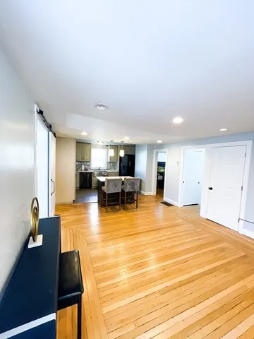 a room with pool table and chairs