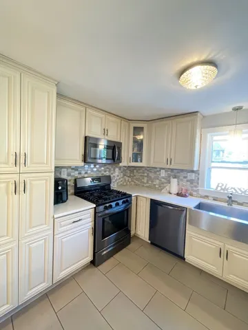 a kitchen with stainless steel appliances granite countertop a stove and a sink
