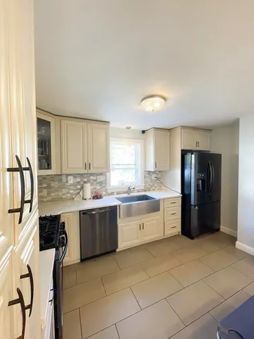 a kitchen with a sink and a stove top oven