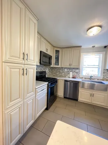a kitchen with granite countertop cabinets and steel stainless steel appliances