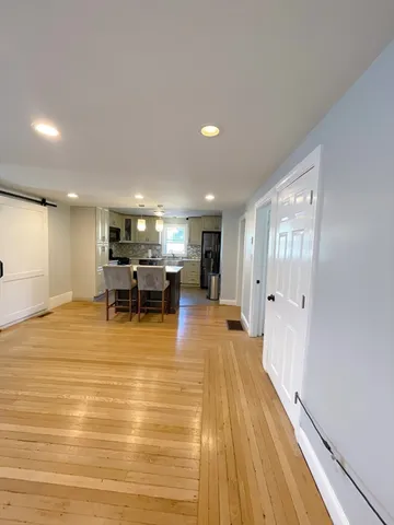 a room with wooden floor and pool table