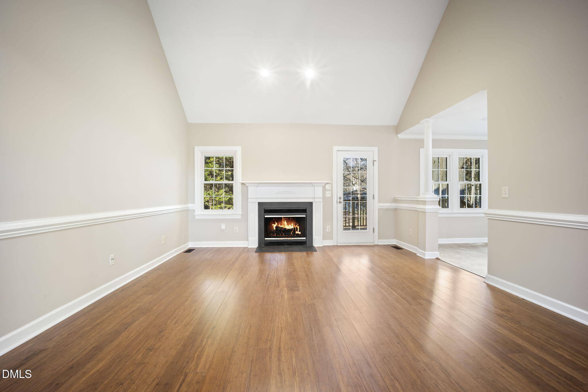 912 Broadhaven Drive Raleigh, NC 27603 - Photo 11 of 53 a view of an empty room with wooden floor fireplace and a window