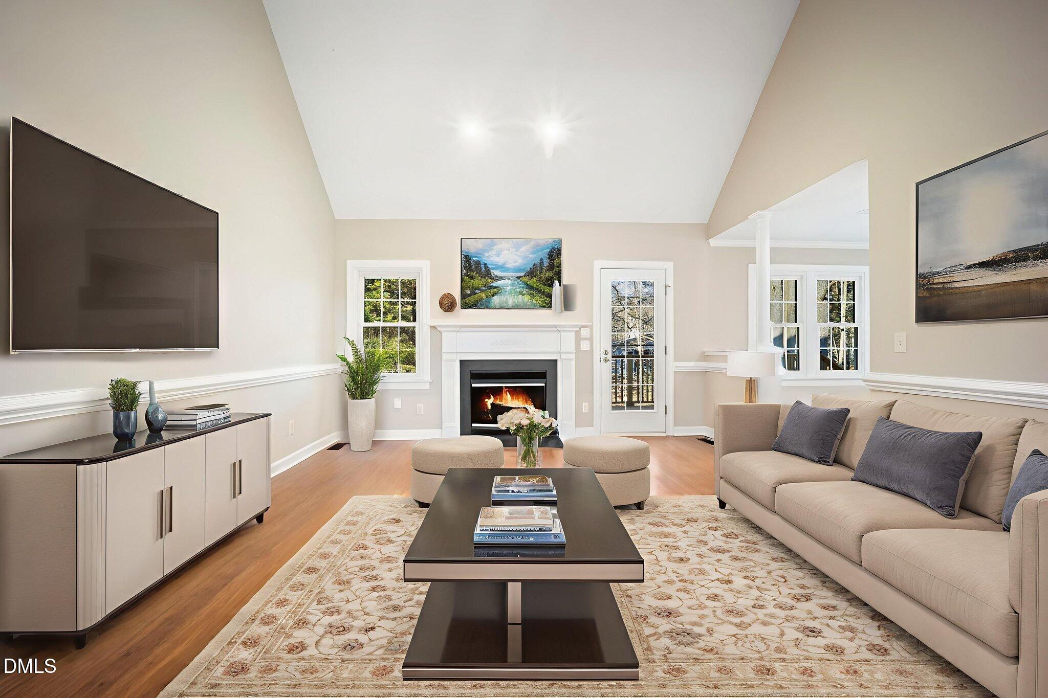 912 Broadhaven Drive Raleigh, NC 27603 - Photo 12 of 53 a living room with furniture a flat screen tv and a fireplace