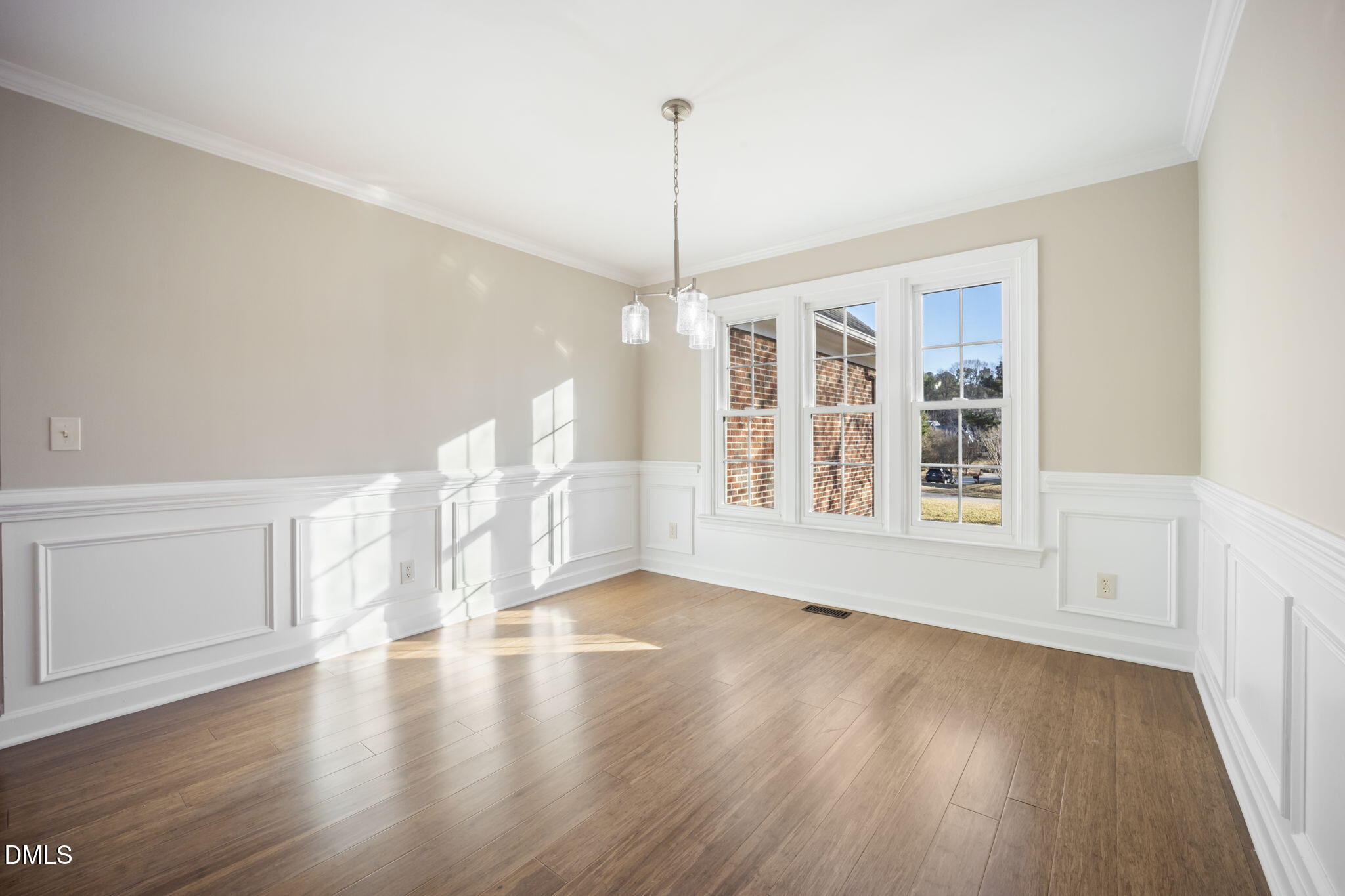 912 Broadhaven Drive Raleigh, NC 27603 - Photo 12 of 51 a view of an empty room with wooden floor and a window