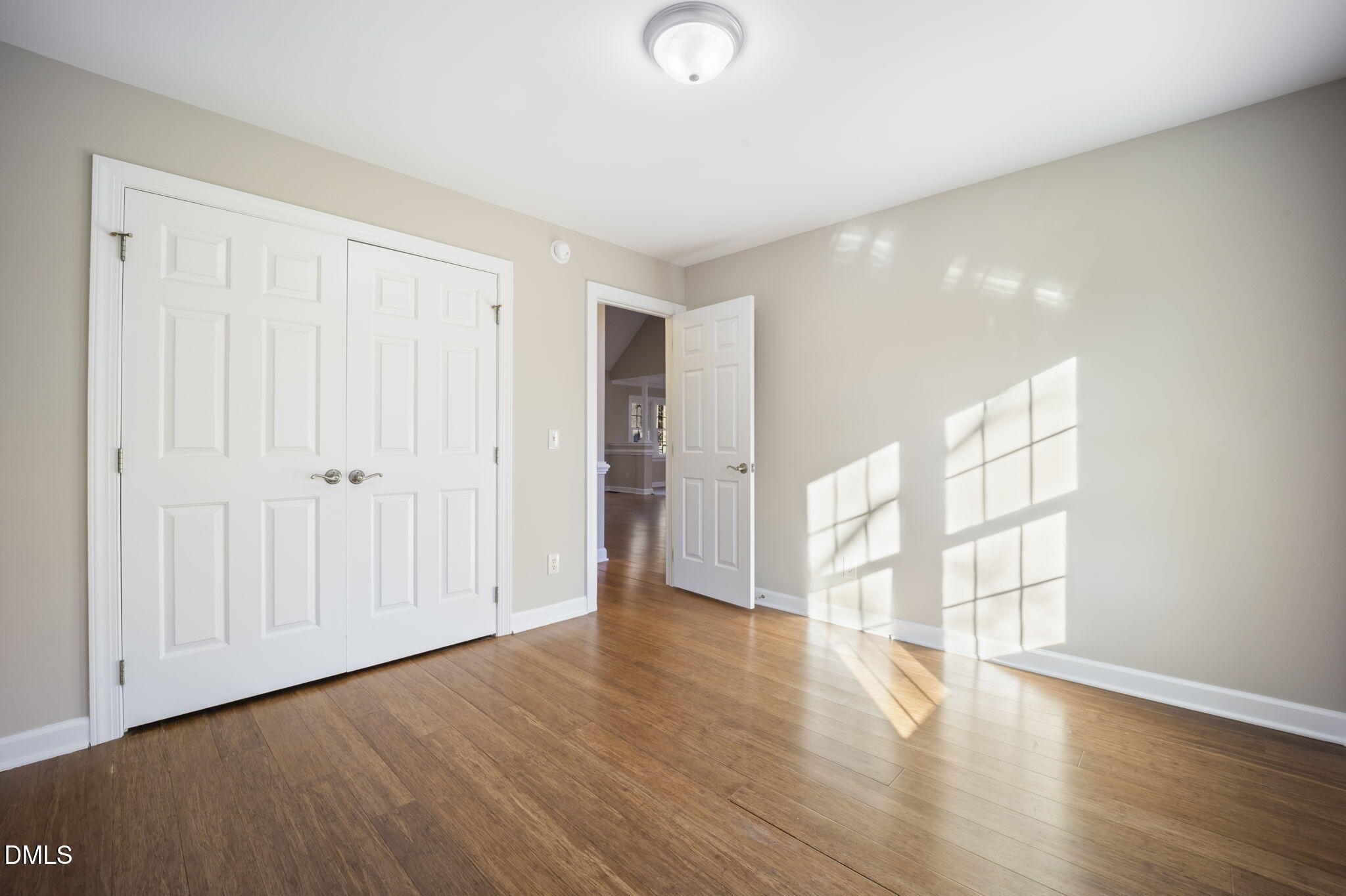 912 Broadhaven Drive Raleigh, NC 27603 - Photo 19 of 53 a view of an empty room with wooden floor and a window