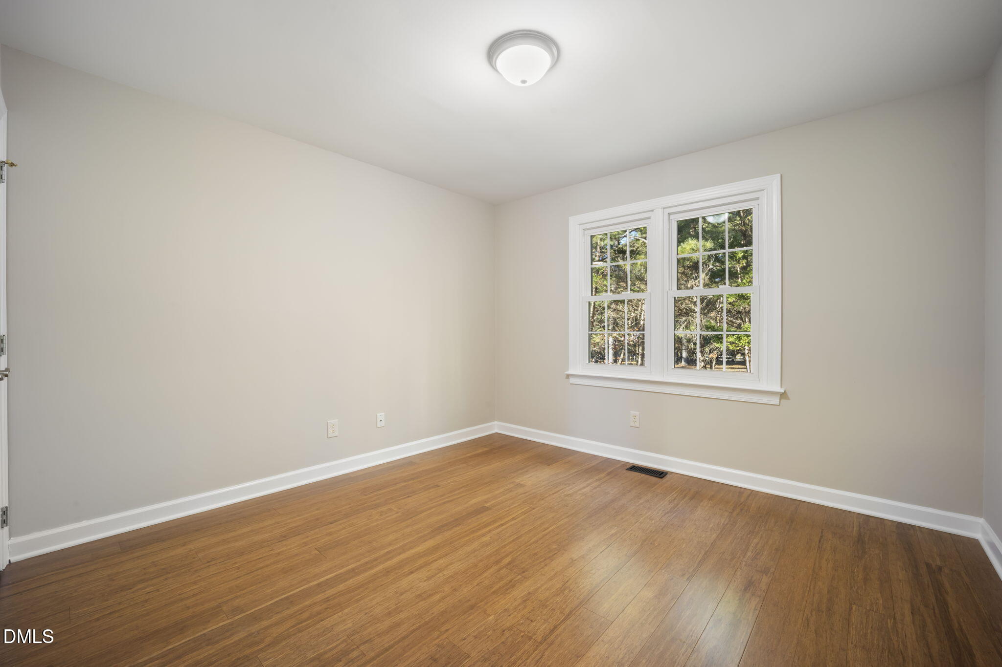 912 Broadhaven Drive Raleigh, NC 27603 - Photo 21 of 53 an empty room with wooden floor and windows