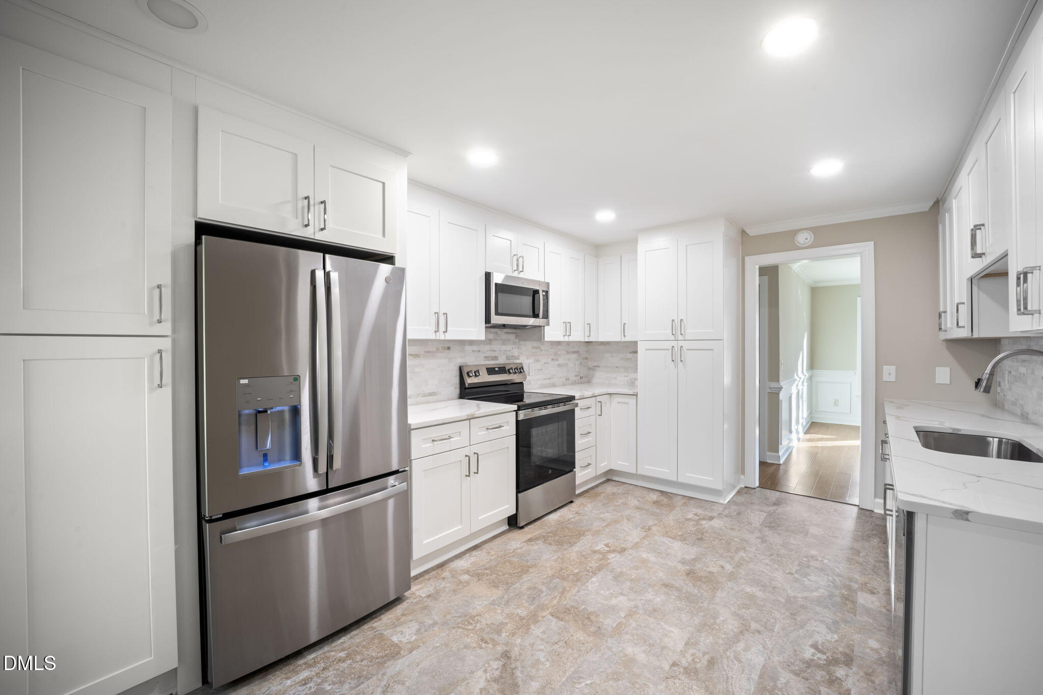 912 Broadhaven Drive Raleigh, NC 27603 - Photo 24 of 53 a kitchen with stainless steel appliances a refrigerator sink and cabinets