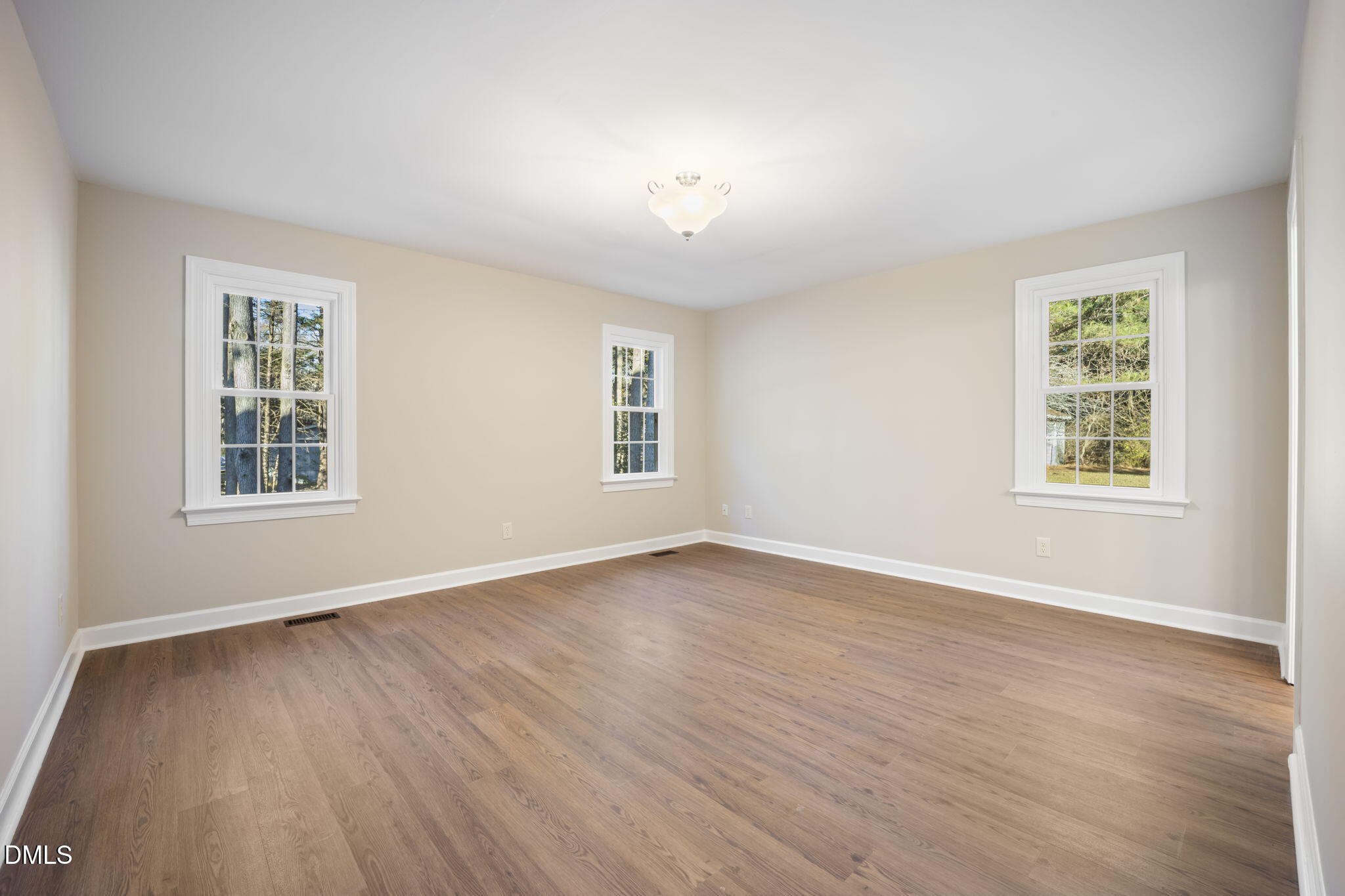 912 Broadhaven Drive Raleigh, NC 27603 - Photo 24 of 51 an empty room with wooden floor and windows