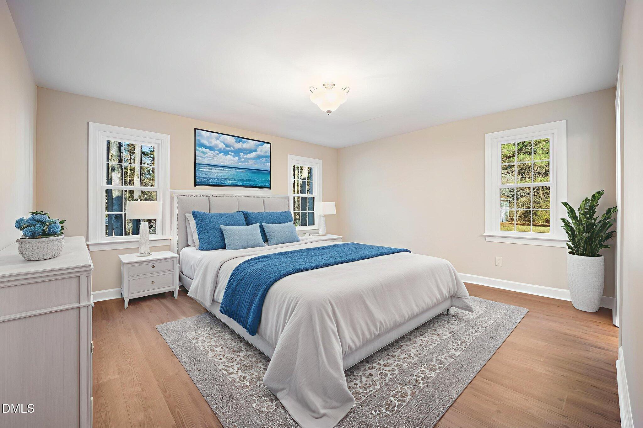 912 Broadhaven Drive Raleigh, NC 27603 - Photo 25 of 51 a bedroom with a large bed lamp and a potted plant