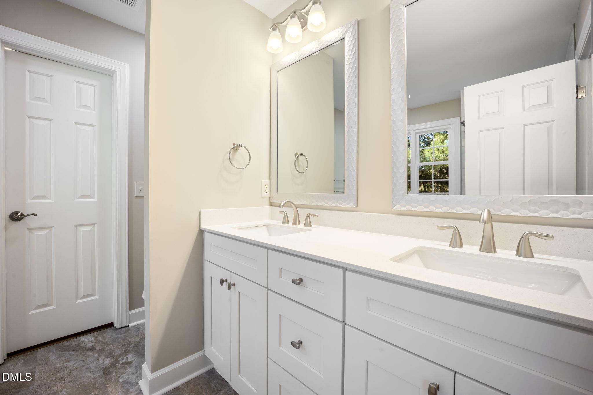 912 Broadhaven Drive Raleigh, NC 27603 - Photo 27 of 51 a bathroom with a double vanity sink and a mirror