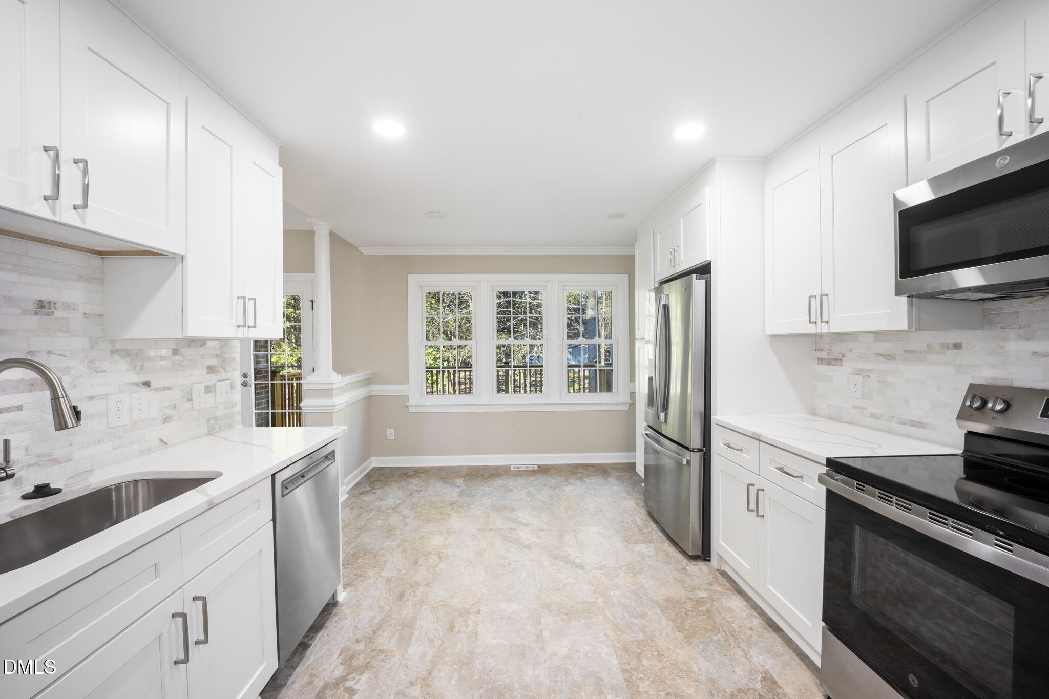 912 Broadhaven Drive Raleigh, NC 27603 - Photo 28 of 53 a kitchen with stainless steel appliances a sink stove and cabinets