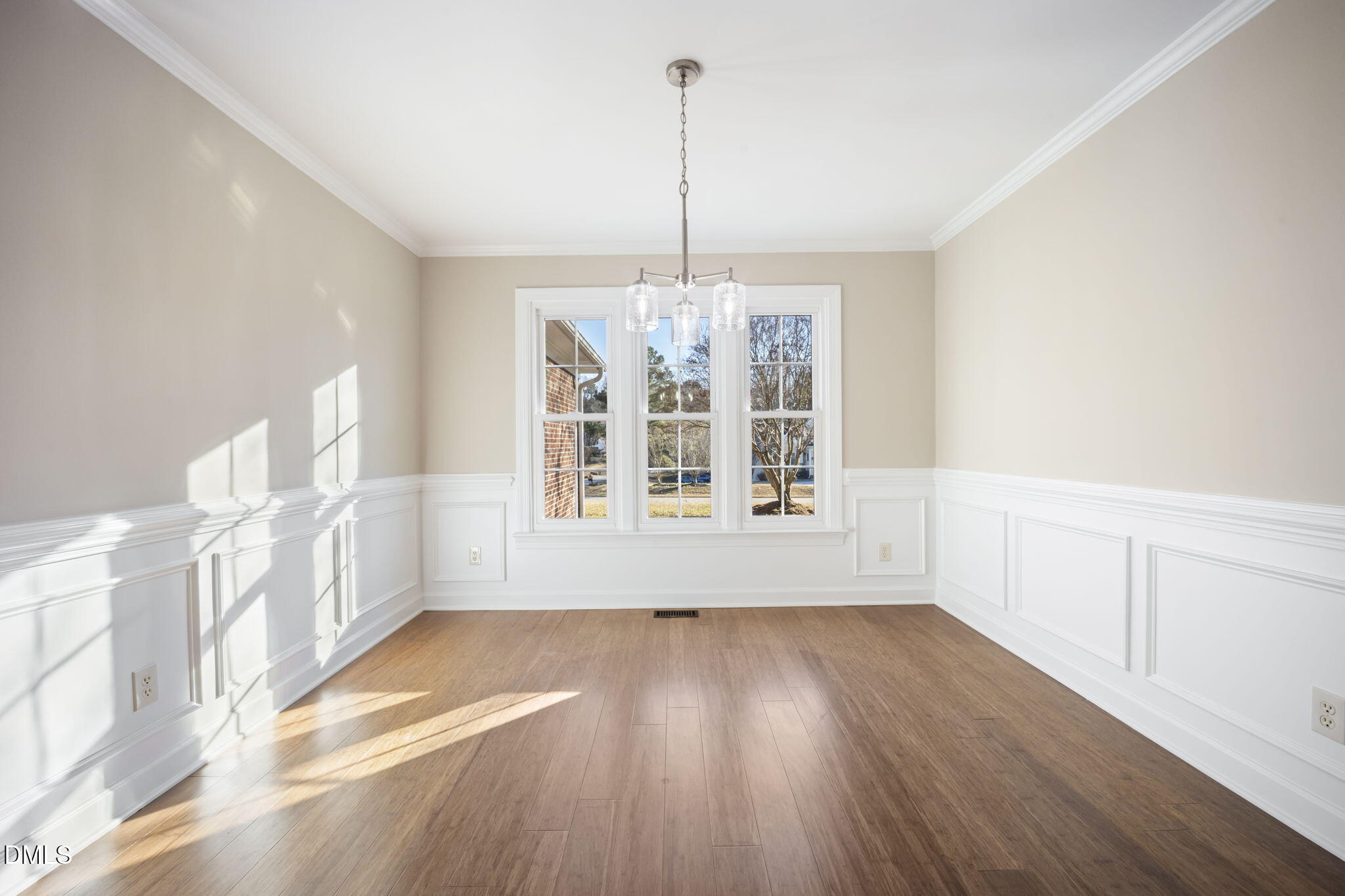 912 Broadhaven Drive Raleigh, NC 27603 - Photo 7 of 51 a view of an empty room with a window and wooden floor